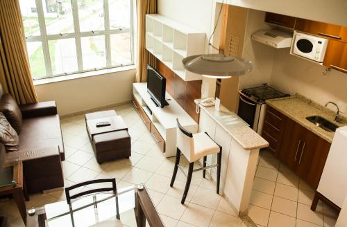 a small kitchen with a table and chairs in it at Hotel City Hall in São José dos Campos