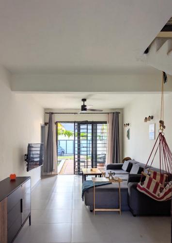 a living room with a couch and a table at Jabali in Roches Noires
