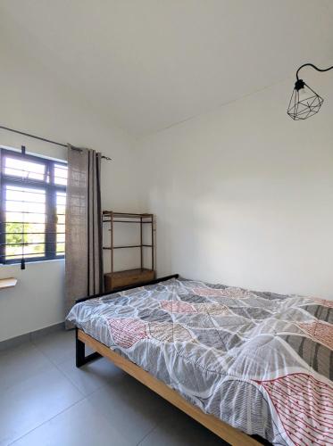 a bedroom with a bed and a window at Jabali in Roches Noires