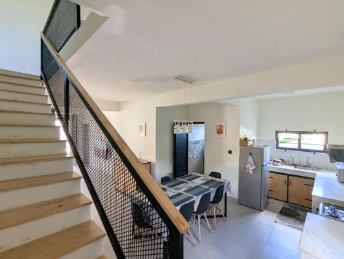a living room with a staircase and a kitchen at Jabali in Roches Noires