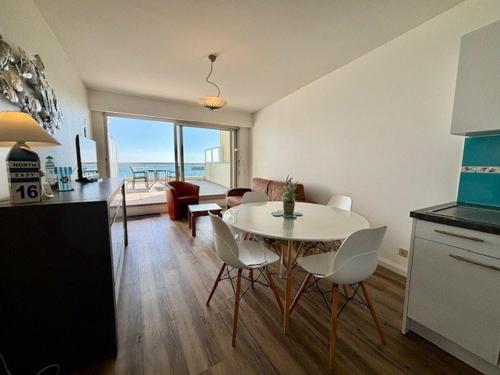 une cuisine et un salon avec une table et des chaises dans l'établissement Quiberon - Appartement 2 pièces, grande terrasse face mer, parking, animaux acceptés - FR-1-478-119, à Quiberon