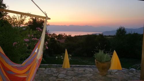 a view of the sunset from a patio with a tent at Villa Velestovo in Ohrid