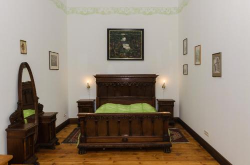 a bedroom with a wooden bed in a room at Ēdoles Pils in Ēdole