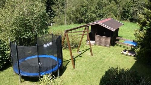 a gazebo and a play house in a yard at Ferienwohnung Nr 2, Lechbruck-Gründl, Allgäu in Prem