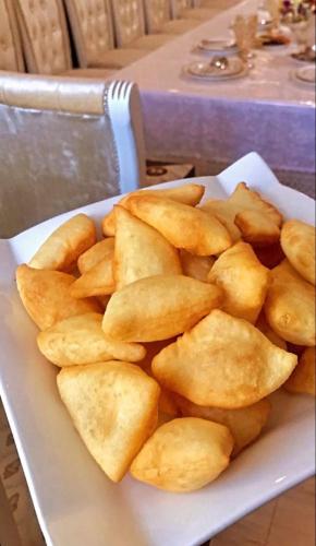 a plate of fried potatoes on a table at Jazel Guest House in Kazarman
