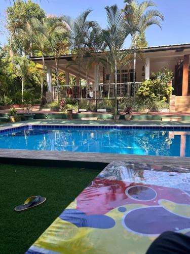a swimming pool in front of a house at Kindo Kicha Farmhouse in Moshi
