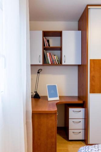 a desk with a laptop on it in a bedroom at Laganini in Jesenice