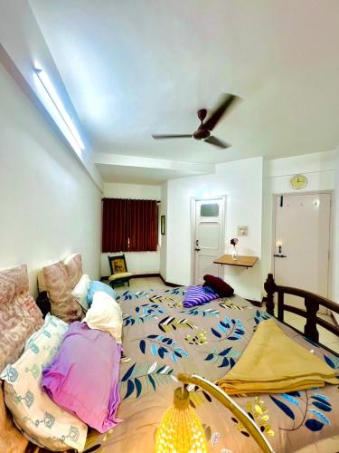 a bedroom with a large bed and a ceiling at Serene Guest House ll 2 Ac Rooms ll WiFi ll Tv ll Garden in Khandala