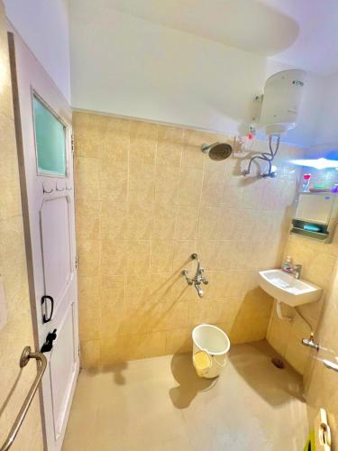 a bathroom with a toilet and a sink at Serene Guest House ll 2 Ac Rooms ll WiFi ll Tv ll Garden in Khandala
