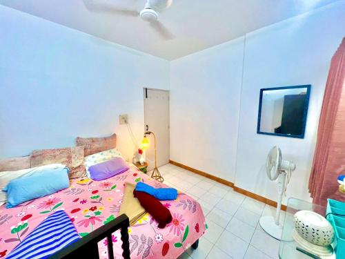 a bedroom with a pink bed and a phone at Serene Guest House ll 2 Ac Rooms ll WiFi ll Tv ll Garden in Khandala