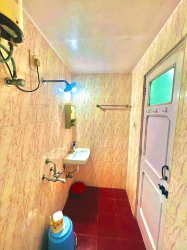 a small bathroom with a sink and a toilet at Serene Guest House ll 2 Ac Rooms ll WiFi ll Tv ll Garden in Khandala