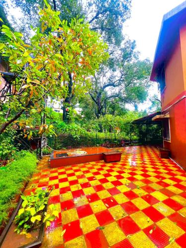 a red and yellow checkered floor in a garden at Serene Guest House ll 2 Ac Rooms ll WiFi ll Tv ll Garden in Khandala