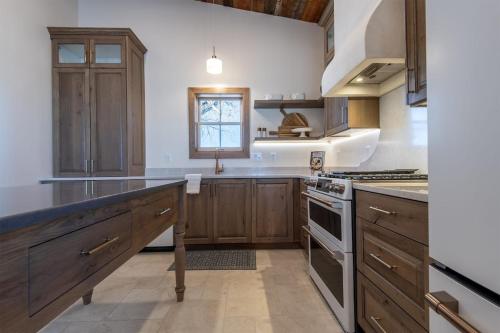 a kitchen with wooden cabinets and a counter top at Historic Homestead with Pond and Teton Range Views in Tetonia