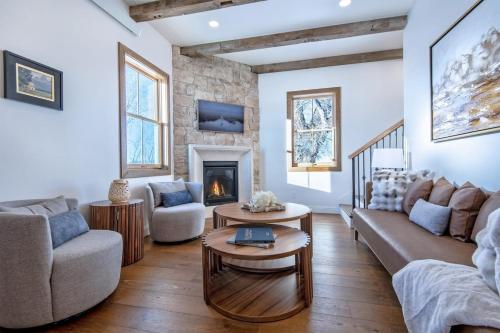 a living room with a couch and a fireplace at Historic Homestead with Pond and Teton Range Views in Tetonia