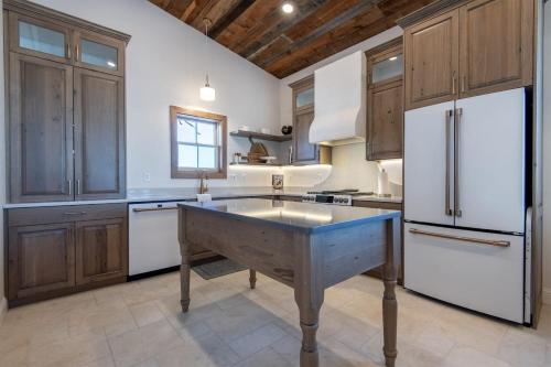 a kitchen with a large island in the middle at Historic Homestead with Pond and Teton Range Views in Tetonia