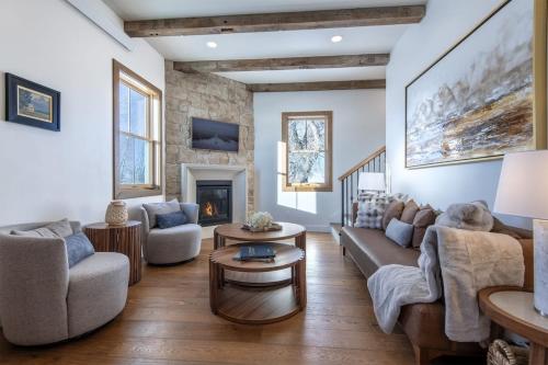 a living room with a couch and chairs and a fireplace at Historic Homestead with Pond and Teton Range Views in Tetonia