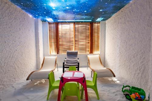 a room with chairs and a table and a ceiling with stars at Emerald Beach Resort & Spa in Ravda