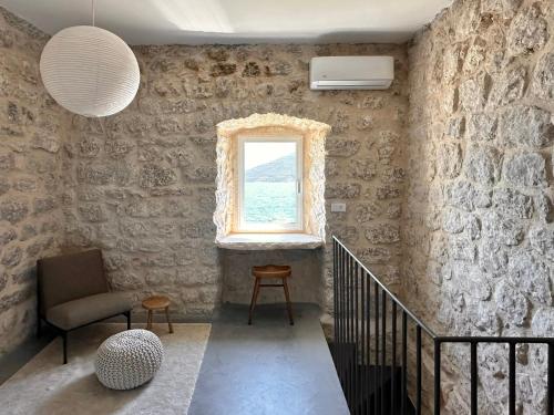 a room with a staircase with a window and a chair at Strp House in Strp