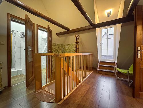 a hallway with a wooden staircase in a house at Ferienhaus Im Gässchen in Bad Sulza
