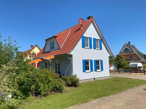 a white house with an orange roof at A 5 Ferienhaus Triton in Gramkow