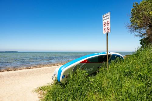 a car parked on the beach next to a speed limit sign at A 5 Ferienhaus Triton in Gramkow