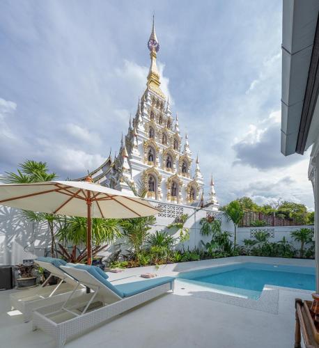 a resort with a swimming pool and a building at Santitham Pool Villa I 5 Bedrooms I walkable I Entire villa I Daily Housekeeping in Chiang Mai