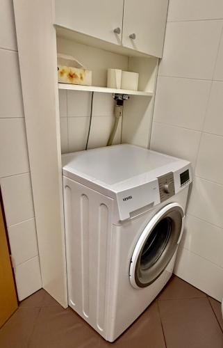a washer and dryer in a small room at Sunflower Apartment Moravske Toplice in Moravske Toplice