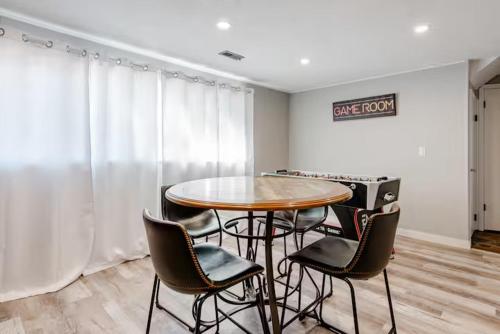 a dining room with a table and four chairs at Spacious 4 bdr w/ Game Room 5 min Drive to College in Boulder