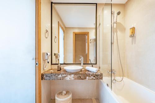 a bathroom with a sink and a shower and a tub at Luxurious Apartment in Marrakech in Dar Caïd Layadi