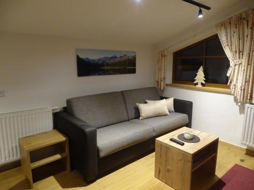 a living room with a couch and a table at Ziegenblick in Nauders