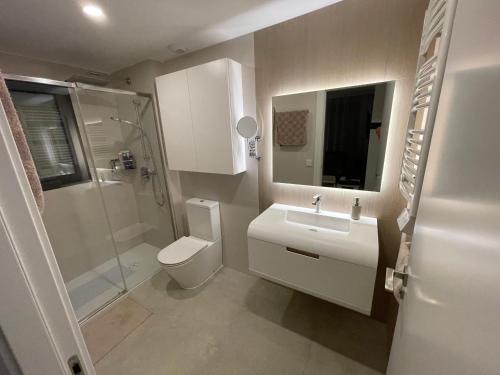 a bathroom with a toilet and a sink and a shower at Gran Alcant Iconic Apartment Riki in Gran Alacant