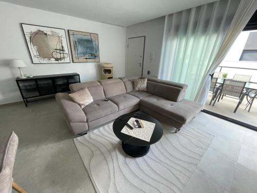 a living room with a couch and a table at Gran Alcant Iconic Apartment Riki in Gran Alacant