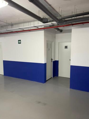 an empty room with blue and white walls and white floors at Gran Alcant Iconic Apartment Riki in Gran Alacant