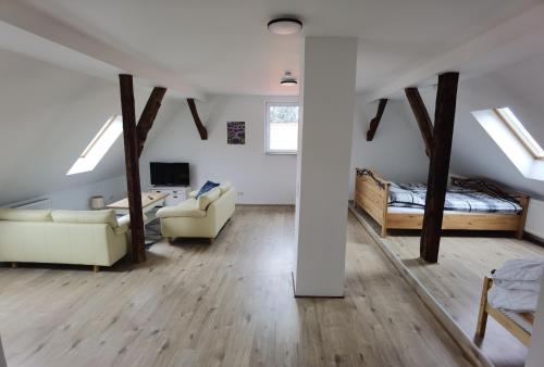 a living room with a bed and a couch at Ferienwohnung am Backhaus 6 in Weimar