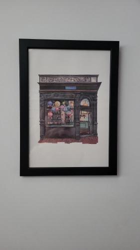 a framed picture of a fireplace on a wall at Ca Na Martina in Carreña de Cabrales 