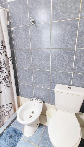 a bathroom with a toilet and a sink at Depto Valle del Sol,cerca GOLF CLUB VILLA ALLENDE in Mendiolaza