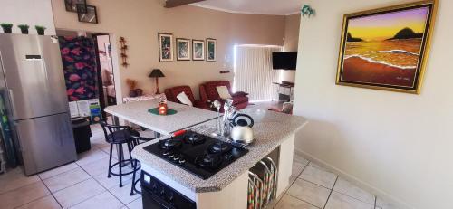 a kitchen with a stove and a counter top at The Third Dolphin in Herolds Bay