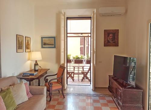 a living room with a couch and a television at Have a nice stay in Rome 2 in Rome