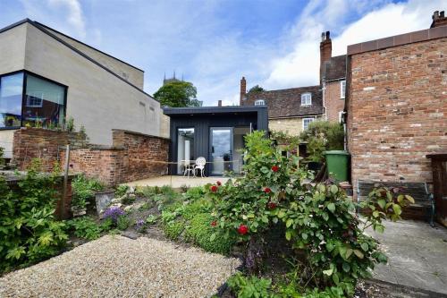 a brick house with a garden in front of it at Stylish and private in the Cathedral Quarter in Lincoln