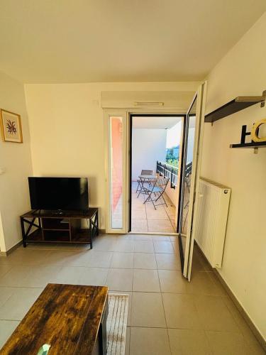 d'un salon avec une table et une vue sur un balcon. dans l'établissement Le Cocon Familial - 4 Personnes, à Tours