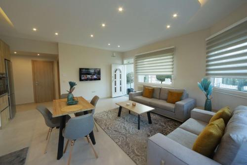 a living room with a couch and a table at Comfort Stay Villas in Kastoria