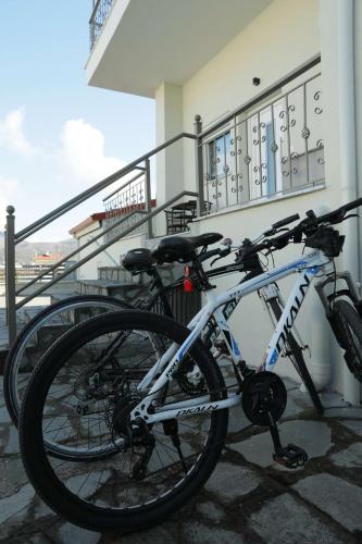 two bikes are parked next to a building at Comfort Stay Villas in Kastoria