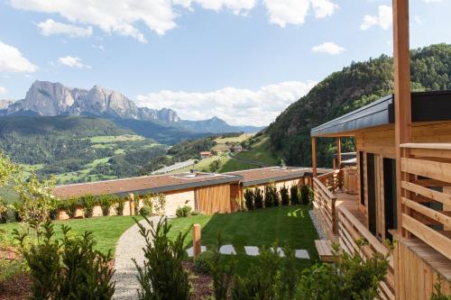 a house with a view of the mountains at Hotel-Chalet Pennhof in Barbiano