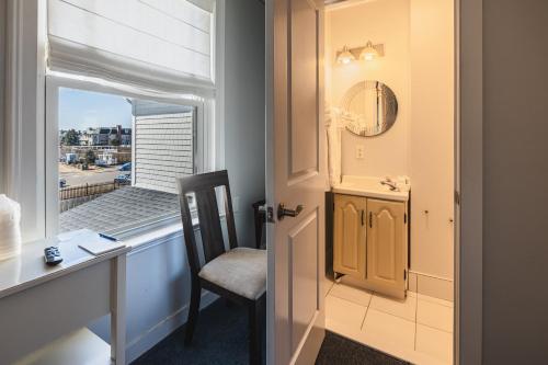 a door leading into a room with a desk and a window at Grand Victorian an ICONA Boutique Collection in Spring Lake