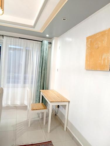a table and a chair in a room at Luxurious Spacious 3bedroom apartment Nyali Mombasa in Mombasa