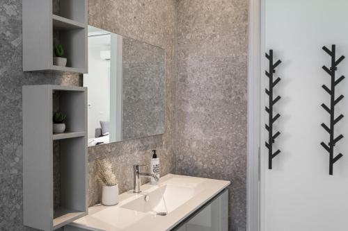 a bathroom with a sink and a mirror at Azimuth Houses in Pollonia