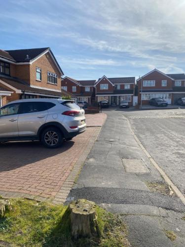 a car parked in a parking lot in front of houses at Budget Room in Wolverhampton in Coseley