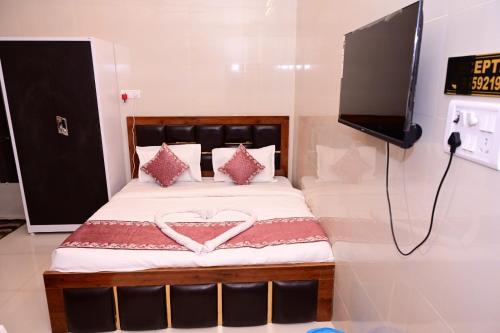a bedroom with a bed with a heart on it at Shri Ram Lalla International in Ayodhya