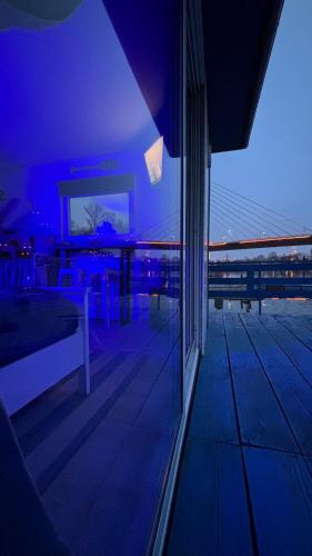 a room with a balcony with a view of a bridge at Oh, Mon Bateau! No running water, bez tekuce vode in Belgrade