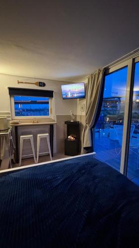 a living room with a fireplace and a large window at Oh, Mon Bateau! No running water, bez tekuce vode in Belgrade